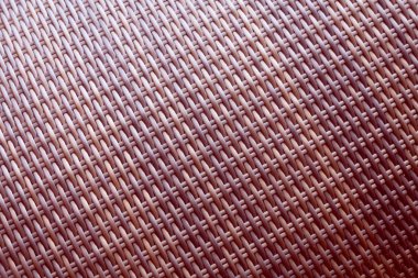 Sentetik rattan dokuma arka planı bahçe mobilyalarında kullanılıyor..