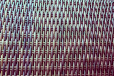 Sentetik rattan dokuma arka planı bahçe mobilyalarında kullanılıyor..