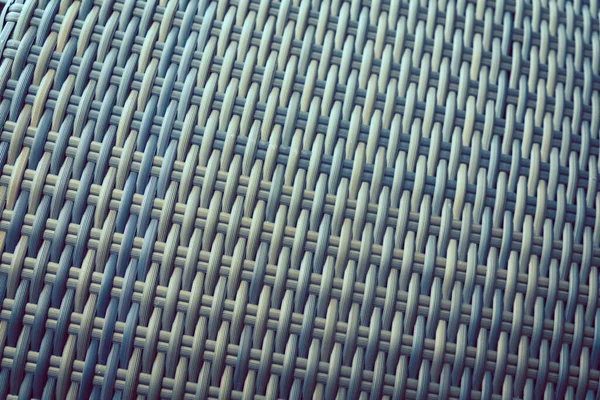 Sentetik rattan dokuma arka planı bahçe mobilyalarında kullanılıyor..