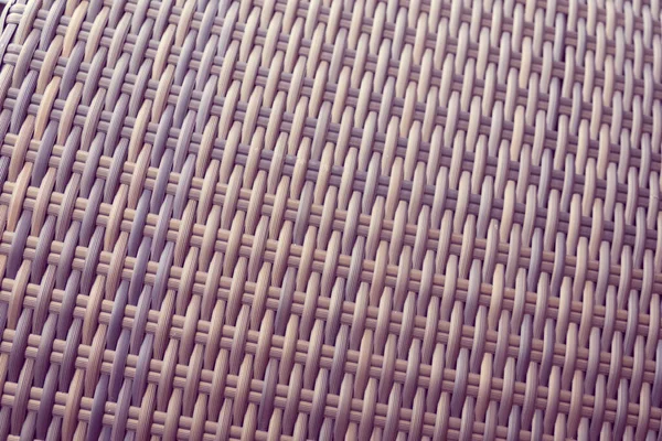 Sentetik rattan dokuma arka planı bahçe mobilyalarında kullanılıyor..