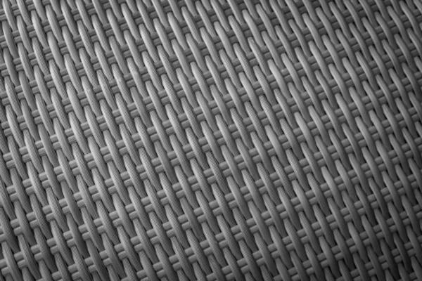 Sentetik rattan dokuma arka planı bahçe mobilyalarında kullanılıyor..