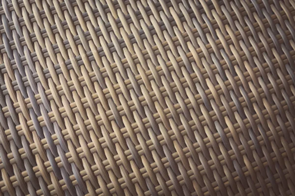Sentetik rattan dokuma arka planı bahçe mobilyalarında kullanılıyor..