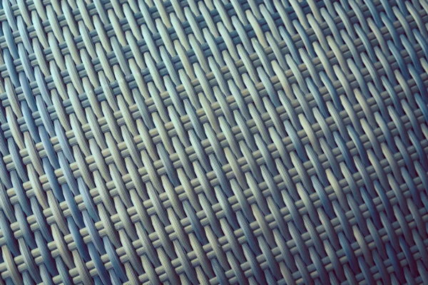 Sentetik rattan dokuma arka planı bahçe mobilyalarında kullanılıyor..