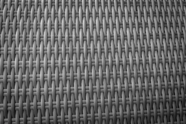 Sentetik rattan dokuma arka planı bahçe mobilyalarında kullanılıyor..