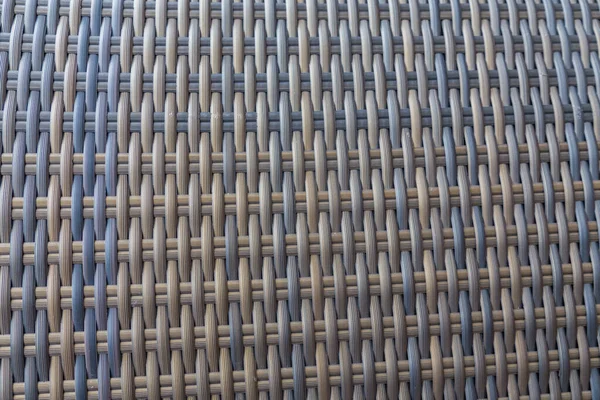 Sentetik rattan dokuma arka planı bahçe mobilyalarında kullanılıyor..
