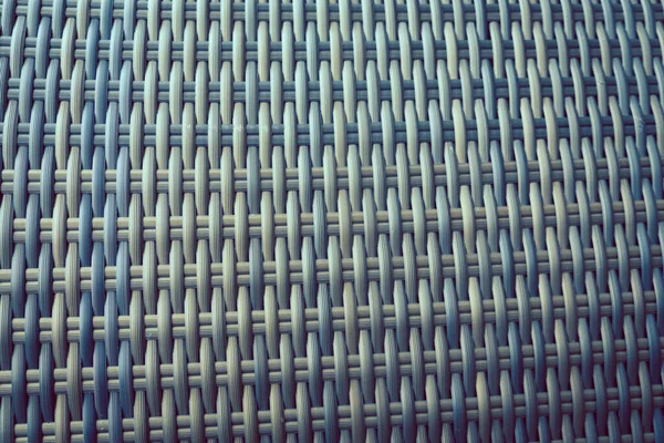 Sentetik rattan dokuma arka planı bahçe mobilyalarında kullanılıyor..