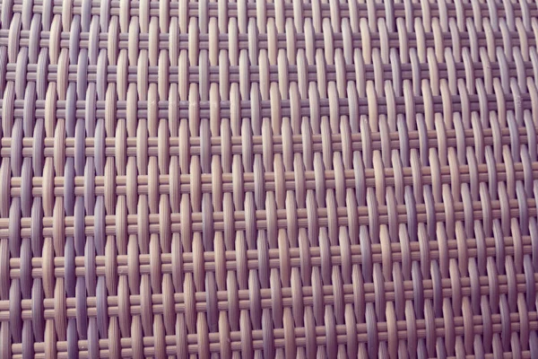 Sentetik rattan dokuma arka planı bahçe mobilyalarında kullanılıyor..