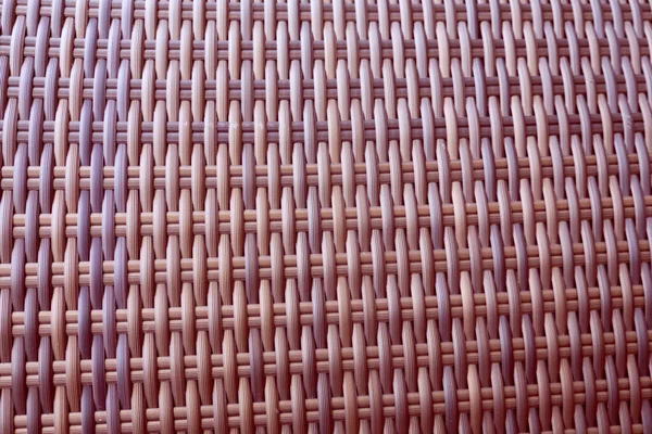 Sentetik rattan dokuma arka planı bahçe mobilyalarında kullanılıyor..