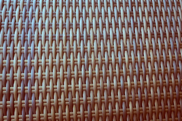 Sentetik rattan dokuma arka planı bahçe mobilyalarında kullanılıyor..
