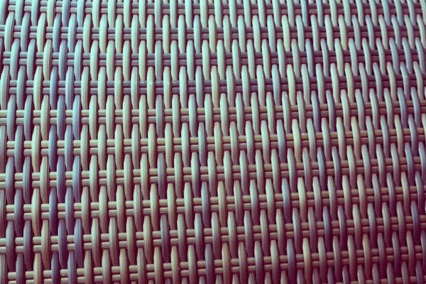 Sentetik rattan dokuma arka planı bahçe mobilyalarında kullanılıyor..