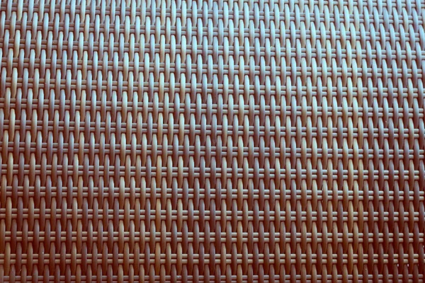 Sentetik rattan dokuma arka planı bahçe mobilyalarında kullanılıyor..