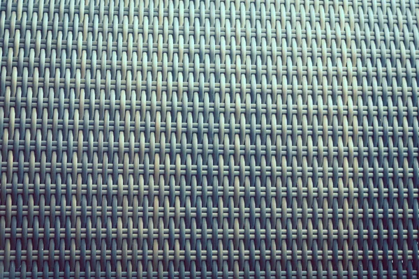 Sentetik rattan dokuma arka planı bahçe mobilyalarında kullanılıyor..