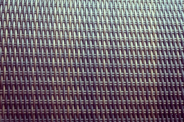 Sentetik rattan dokuma arka planı bahçe mobilyalarında kullanılıyor..