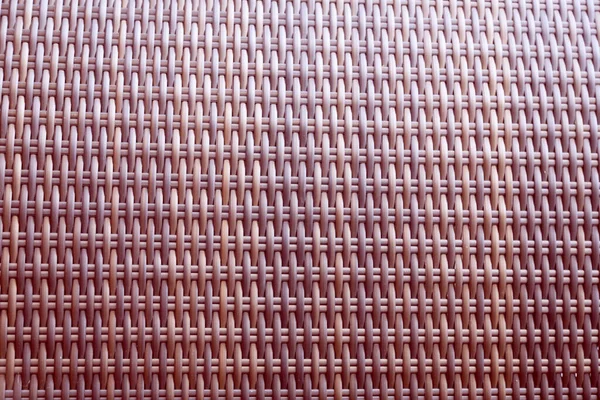 Sentetik rattan dokuma arka planı bahçe mobilyalarında kullanılıyor..