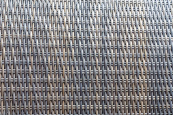 Sentetik rattan dokuma arka planı bahçe mobilyalarında kullanılıyor..