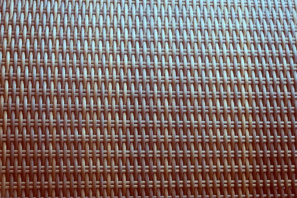 Sentetik rattan dokuma arka planı bahçe mobilyalarında kullanılıyor..