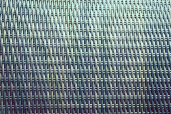 Sentetik rattan dokuma arka planı bahçe mobilyalarında kullanılıyor..