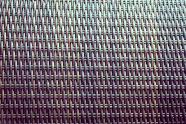 Sentetik rattan dokuma arka planı bahçe mobilyalarında kullanılıyor..