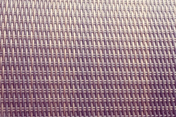 Sentetik rattan dokuma arka planı bahçe mobilyalarında kullanılıyor..