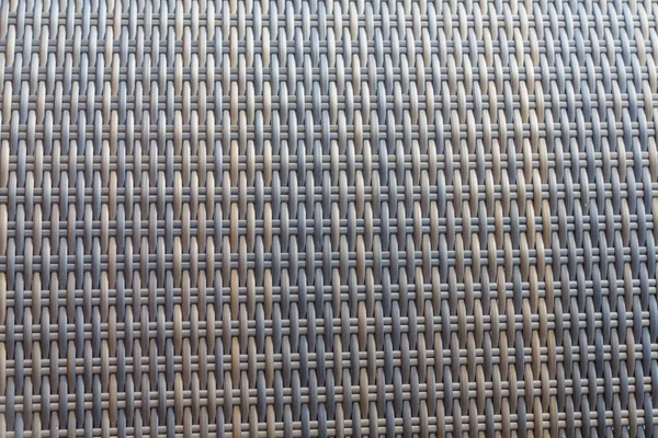 Sentetik rattan dokuma arka planı bahçe mobilyalarında kullanılıyor..