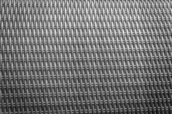 Sentetik rattan dokuma arka planı bahçe mobilyalarında kullanılıyor..