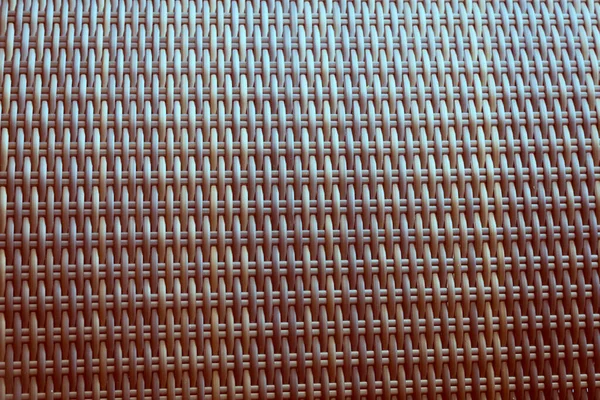 Sentetik rattan dokuma arka planı bahçe mobilyalarında kullanılıyor..