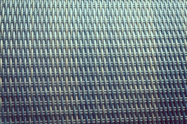 Sentetik rattan dokuma arka planı bahçe mobilyalarında kullanılıyor..