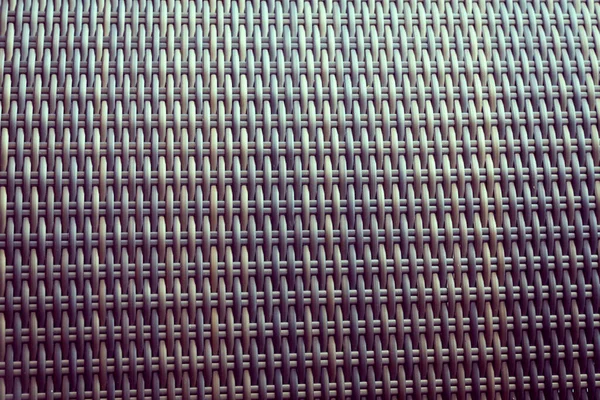 Sentetik rattan dokuma arka planı bahçe mobilyalarında kullanılıyor..