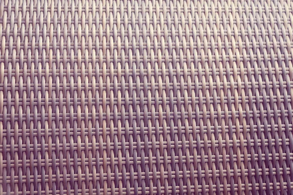 Sentetik rattan dokuma arka planı bahçe mobilyalarında kullanılıyor..