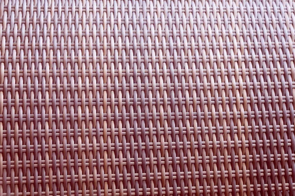 Sentetik rattan dokuma arka planı bahçe mobilyalarında kullanılıyor..