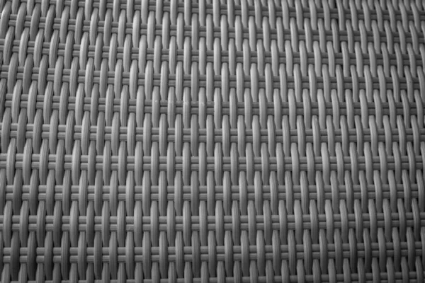 Sentetik rattan dokuma arka planı bahçe mobilyalarında kullanılıyor..