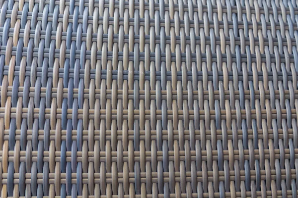 Sentetik rattan dokuma arka planı bahçe mobilyalarında kullanılıyor..