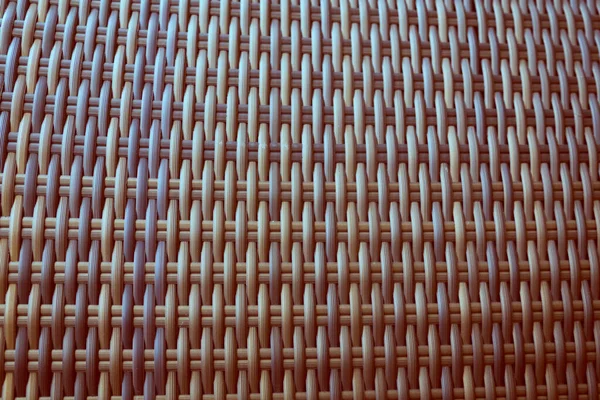 Sentetik rattan dokuma arka planı bahçe mobilyalarında kullanılıyor..
