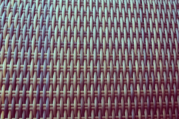 Sentetik rattan dokuma arka planı bahçe mobilyalarında kullanılıyor..