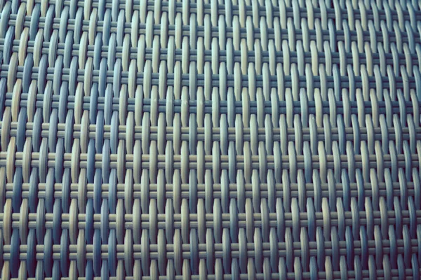 Sentetik rattan dokuma arka planı bahçe mobilyalarında kullanılıyor..