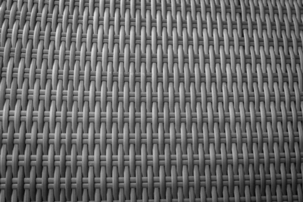 Sentetik rattan dokuma arka planı bahçe mobilyalarında kullanılıyor..