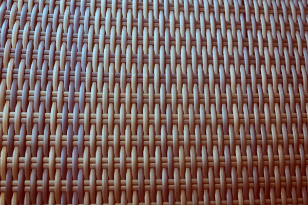 Sentetik rattan dokuma arka planı bahçe mobilyalarında kullanılıyor..