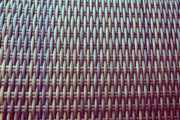 Sentetik rattan dokuma arka planı bahçe mobilyalarında kullanılıyor..