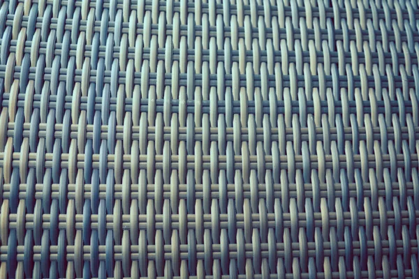 Sentetik rattan dokuma arka planı bahçe mobilyalarında kullanılıyor..