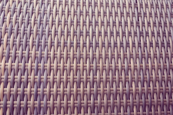Sentetik rattan dokuma arka planı bahçe mobilyalarında kullanılıyor..