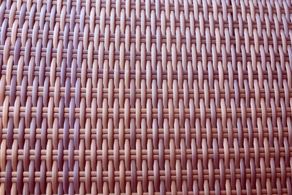 Sentetik rattan dokuma arka planı bahçe mobilyalarında kullanılıyor..