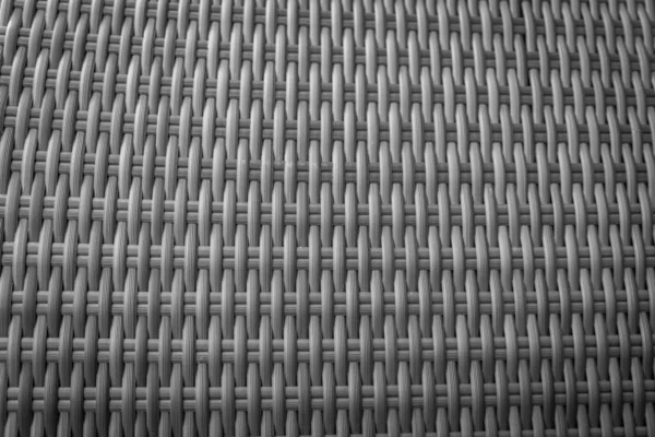 Sentetik rattan dokuma arka planı bahçe mobilyalarında kullanılıyor..