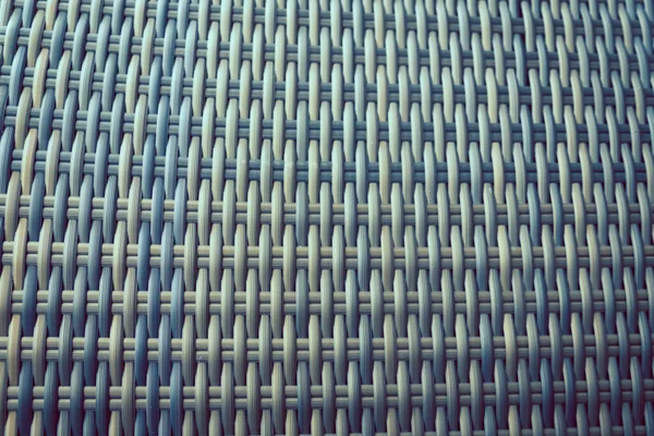 Sentetik rattan dokuma arka planı bahçe mobilyalarında kullanılıyor..