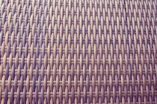 Sentetik rattan dokuma arka planı bahçe mobilyalarında kullanılıyor..