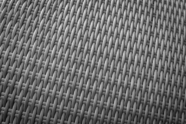 Sentetik rattan dokuma arka planı bahçe mobilyalarında kullanılıyor..