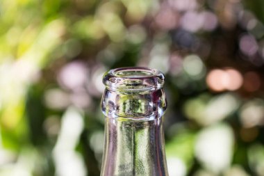 Yeşil bokeh arka planda cam şişe