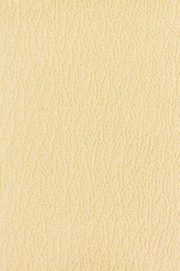 Kanepenin yüzeyinde yapay deri bir arka plan var.