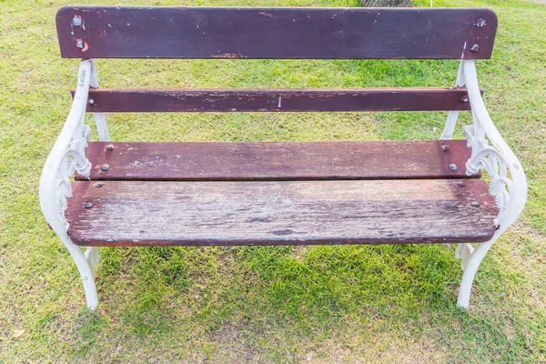 White chair in the park on green grass background