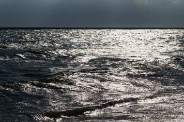 Sahildeki güneş ışığından yansıyan su.