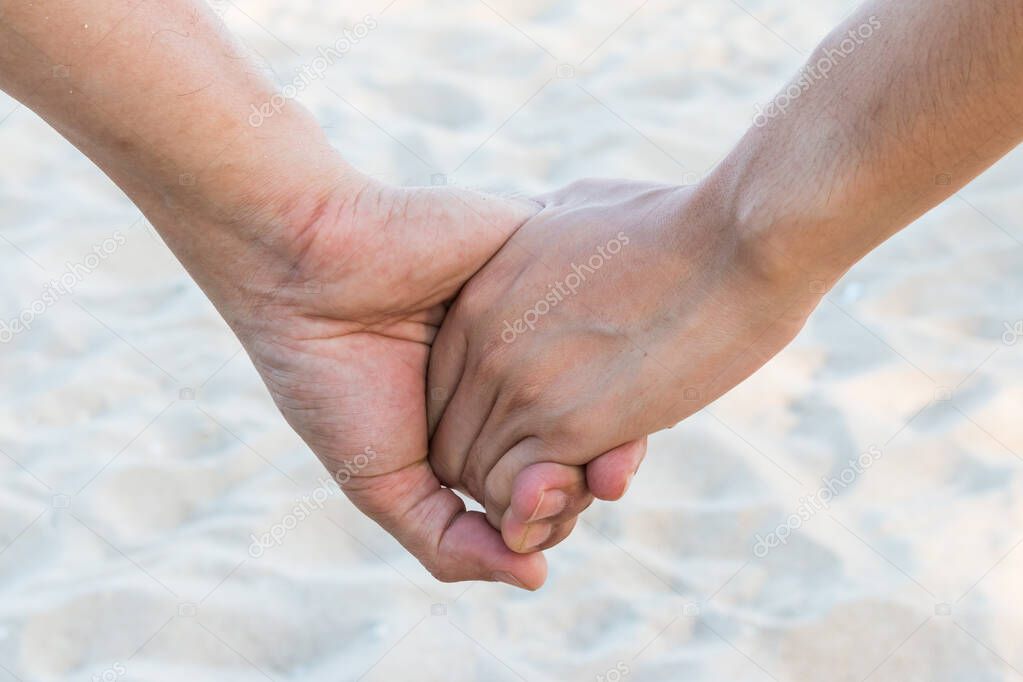 lover hold hand on the beach with sand wave